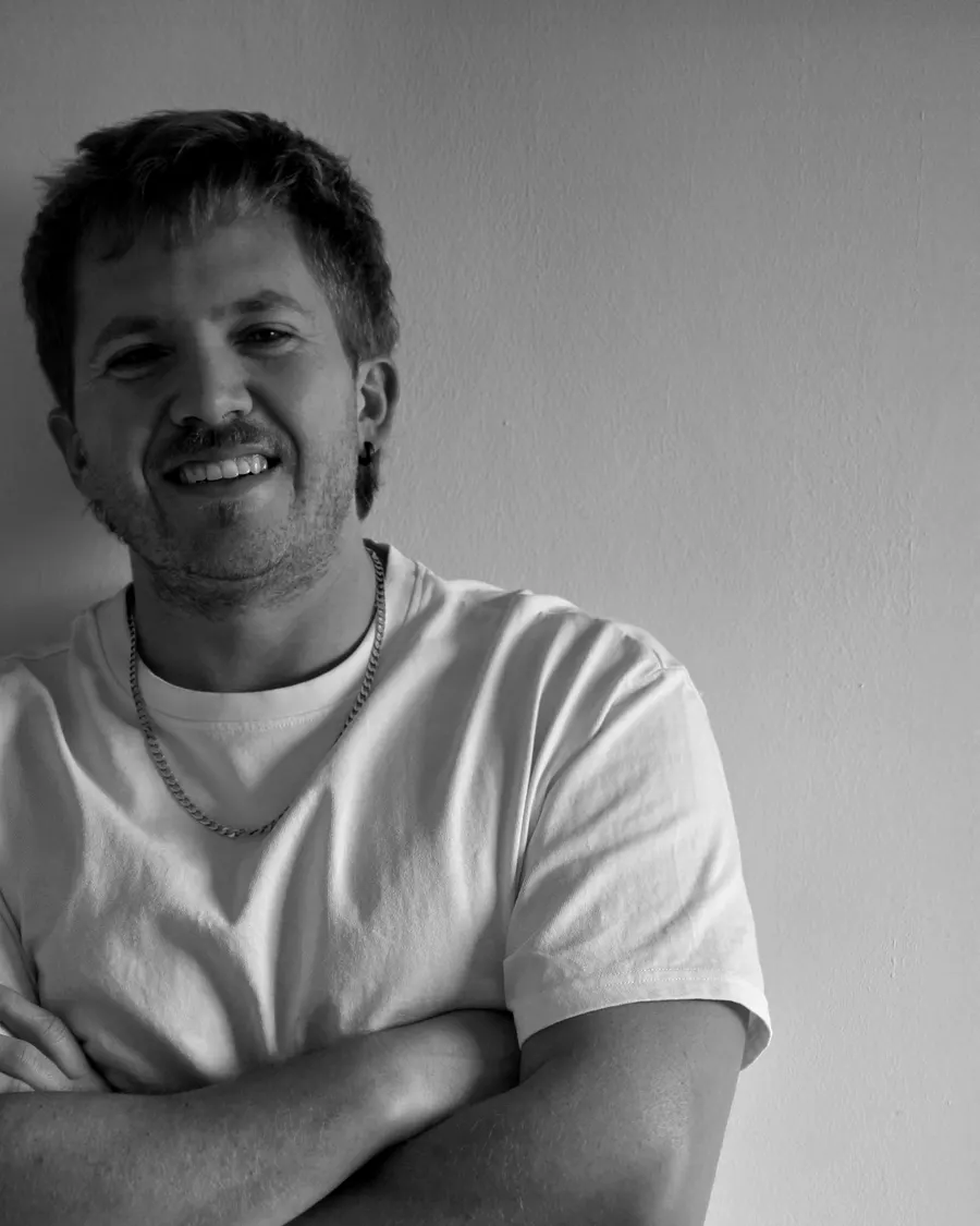 Quewin Human smiling with his arms crossed, black and white